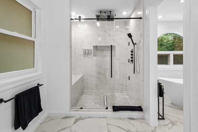 bathroom featuring independent shower and bath