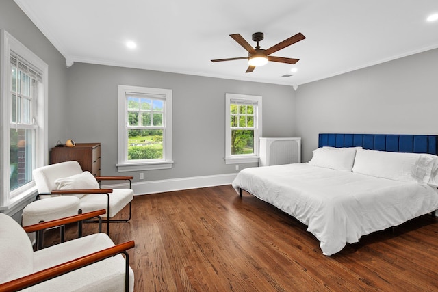 bedroom with ornamental molding, dark wood-type flooring, and ceiling fan