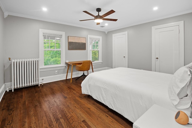 bedroom featuring multiple windows, radiator, and ornamental molding