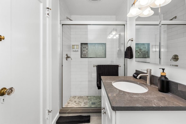 bathroom featuring vanity and an enclosed shower