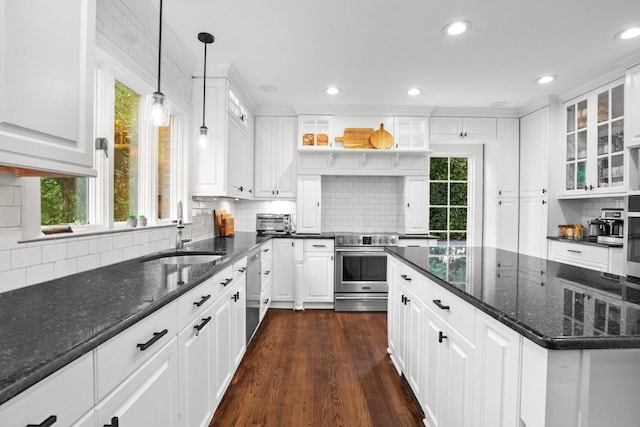 kitchen featuring dark stone countertops, sink, stainless steel appliances, and white cabinets