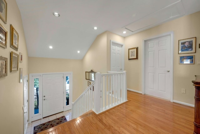 foyer with vaulted ceiling and light hardwood / wood-style flooring