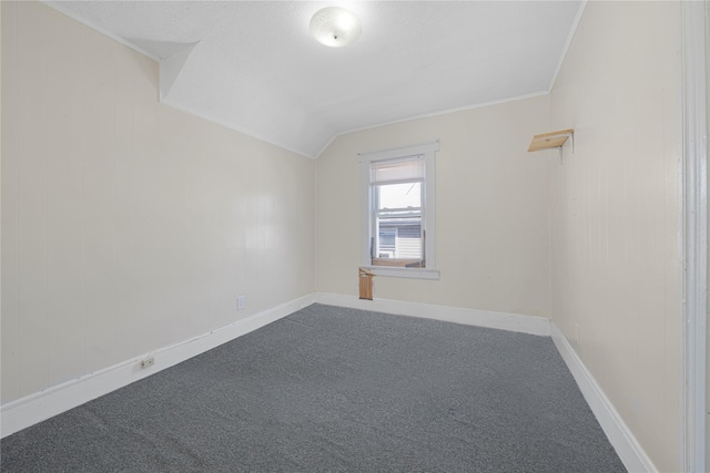 unfurnished room with lofted ceiling and carpet flooring