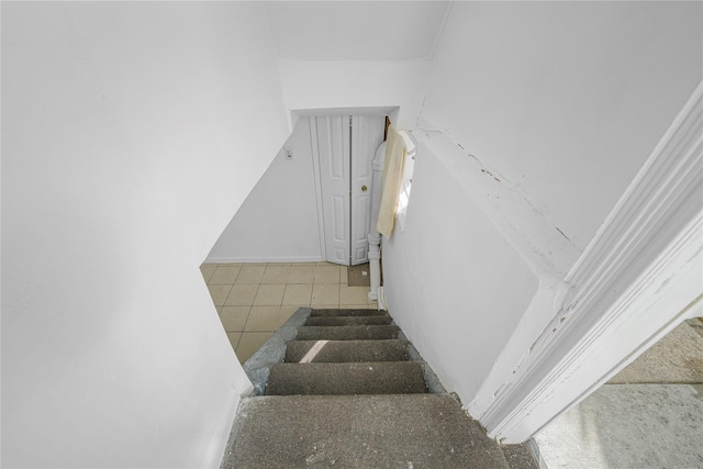 stairway with tile patterned flooring