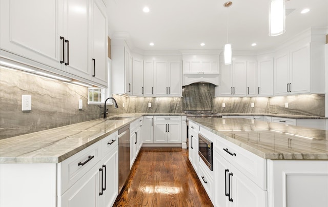 kitchen featuring pendant lighting, light stone counters, white cabinetry, and appliances with stainless steel finishes