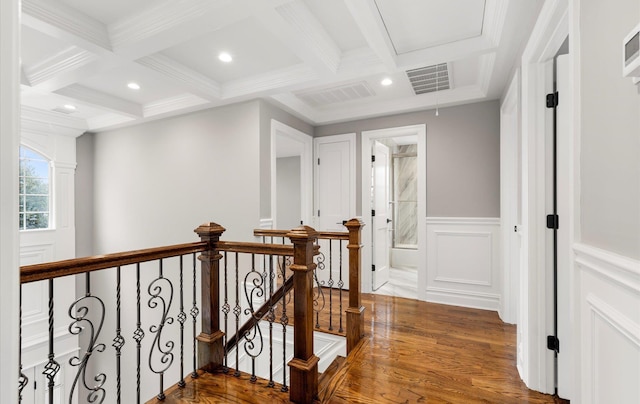 hallway featuring ornamental molding, coffered ceiling, hardwood / wood-style floors, and beam ceiling