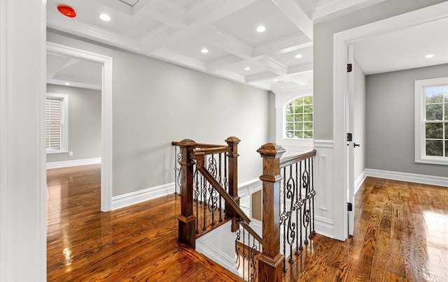 hallway with beamed ceiling, plenty of natural light, coffered ceiling, and hardwood / wood-style floors