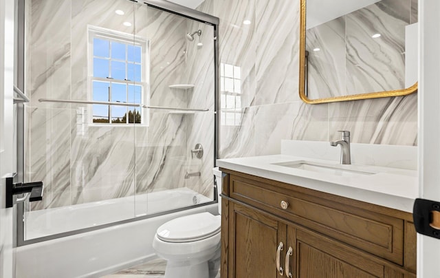 full bathroom featuring vanity, toilet, and combined bath / shower with glass door