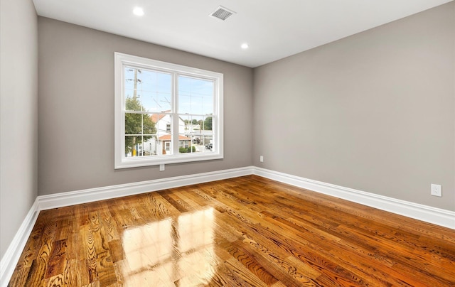 spare room with hardwood / wood-style floors