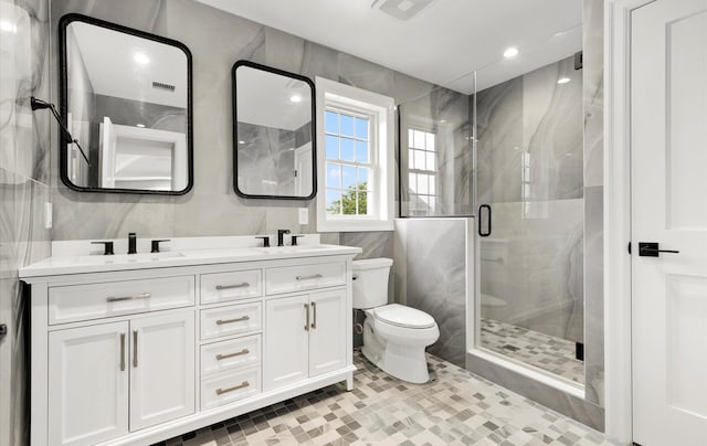 bathroom featuring tile patterned floors, vanity, toilet, and an enclosed shower