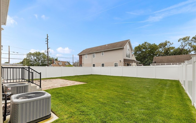 view of yard with a patio and central air condition unit