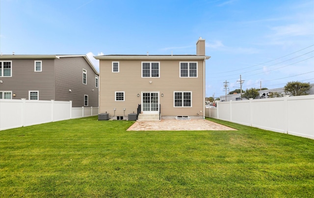 rear view of house featuring a yard, central AC, and a patio