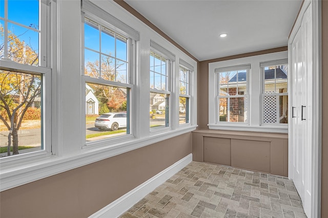 unfurnished sunroom with a healthy amount of sunlight