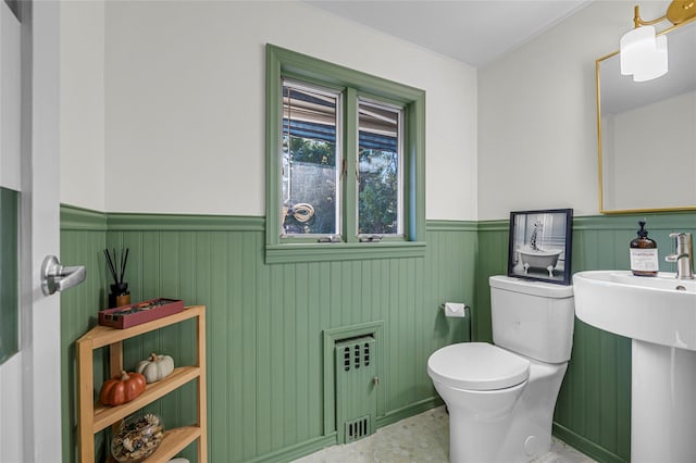 bathroom featuring radiator and toilet