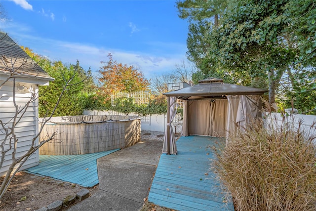 wooden terrace featuring a gazebo