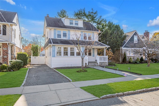 front of property featuring a porch and a front yard