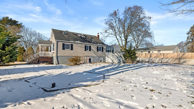 view of snow covered rear of property