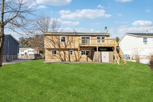 back of house featuring a yard and a deck