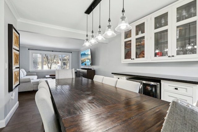 dining space featuring dark wood-type flooring, ornamental molding, bar area, and wine cooler