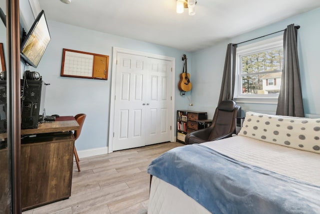 bedroom with a closet and light hardwood / wood-style flooring