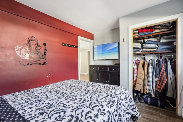 bedroom featuring dark hardwood / wood-style flooring and a closet