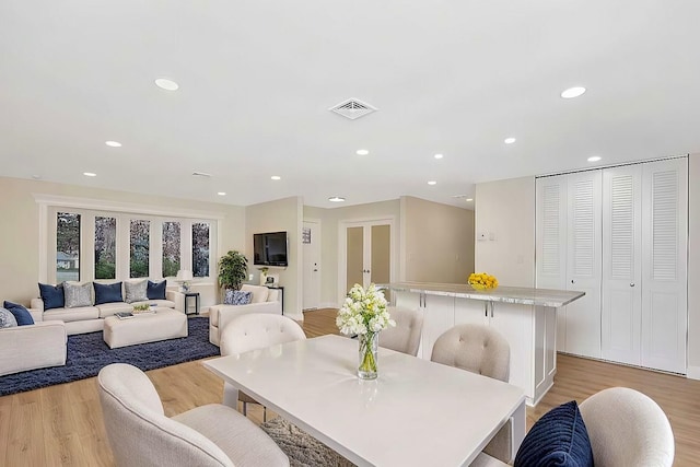 dining space with light wood-type flooring