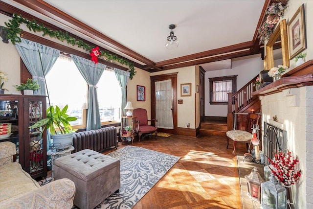 living room with dark parquet flooring, radiator heating unit, and crown molding