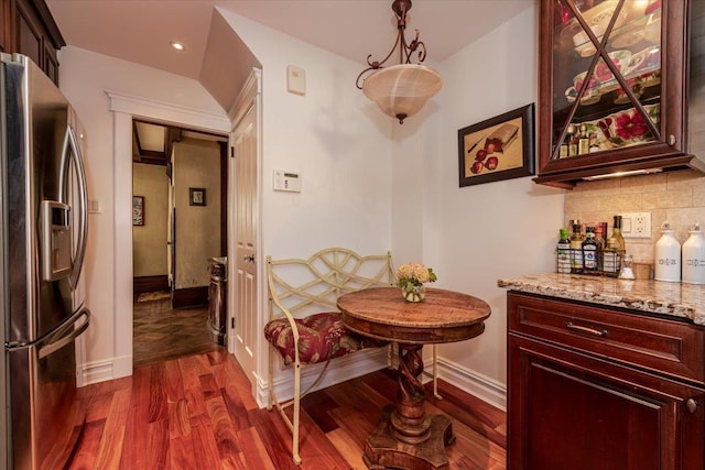 dining room with indoor bar and dark hardwood / wood-style flooring