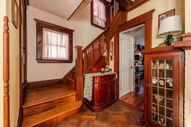 staircase featuring parquet flooring