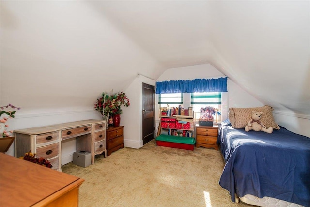 carpeted bedroom featuring lofted ceiling