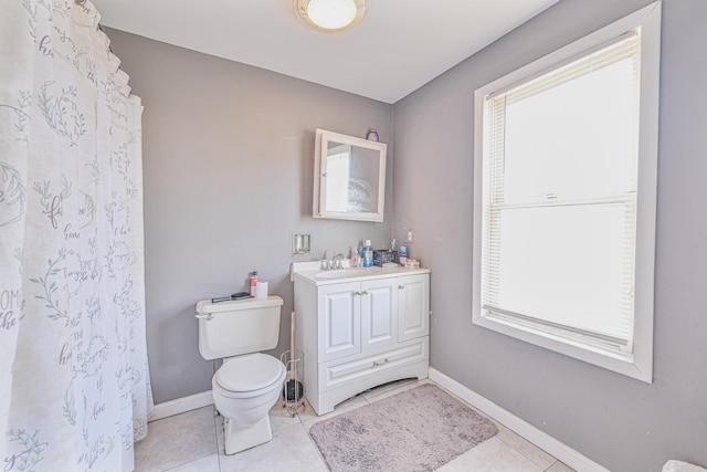 bathroom featuring tile patterned floors, vanity, and toilet