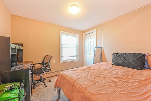 carpeted bedroom with a baseboard heating unit and a closet