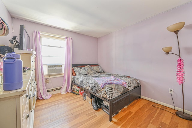 bedroom featuring cooling unit and light hardwood / wood-style flooring