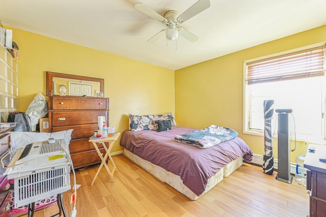 bedroom featuring multiple windows, light wood-type flooring, and ceiling fan