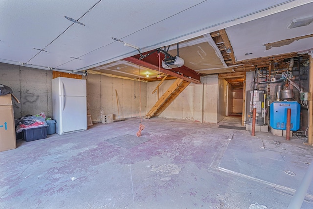 garage with water heater, a garage door opener, and white fridge