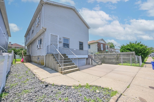 20 E Pine St, Long Beach, NY 11561 - back of property with an attached garage and concrete driveway