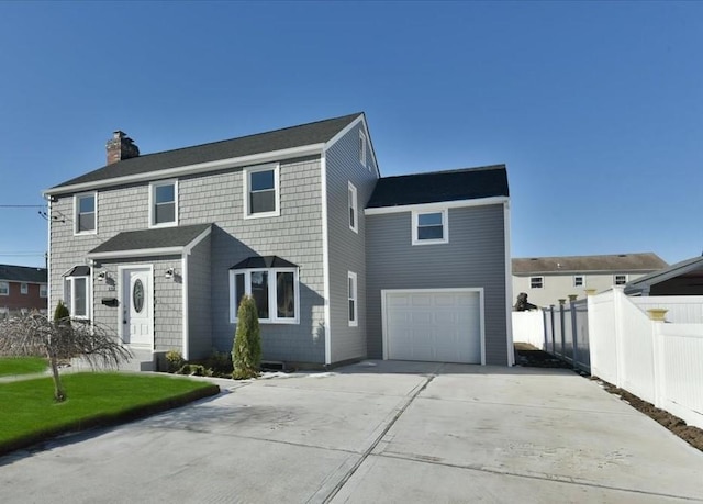 view of front of house with a garage and a front yard