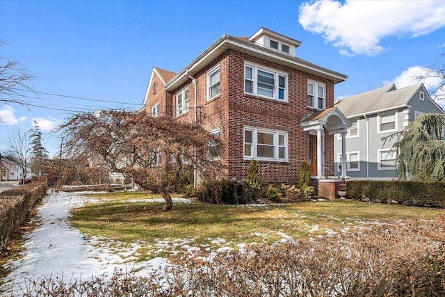 snow covered property featuring a yard