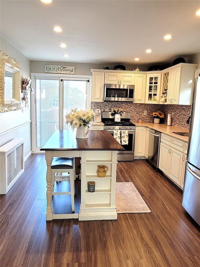 kitchen with white cabinetry, stainless steel appliances, and dark hardwood / wood-style floors