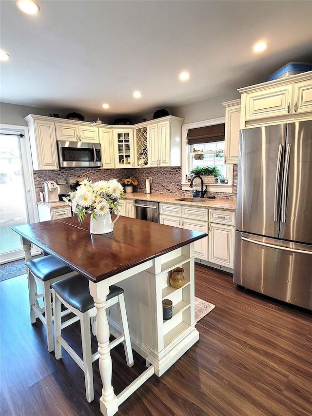 kitchen with dark hardwood / wood-style floors, sink, wooden counters, a center island, and stainless steel appliances