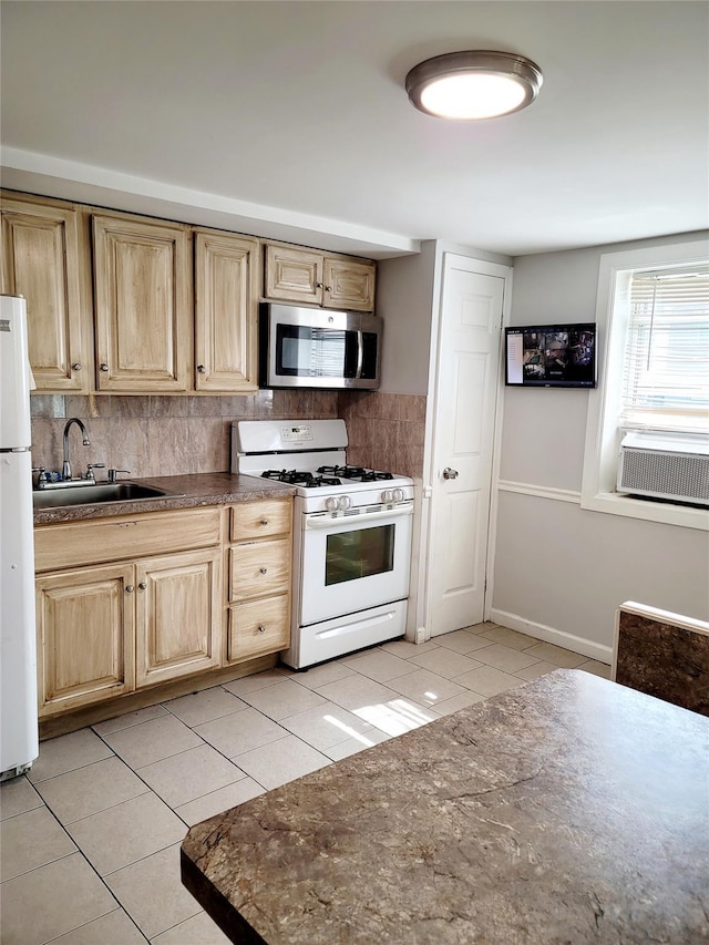 kitchen featuring sink, white appliances, light tile patterned floors, and backsplash