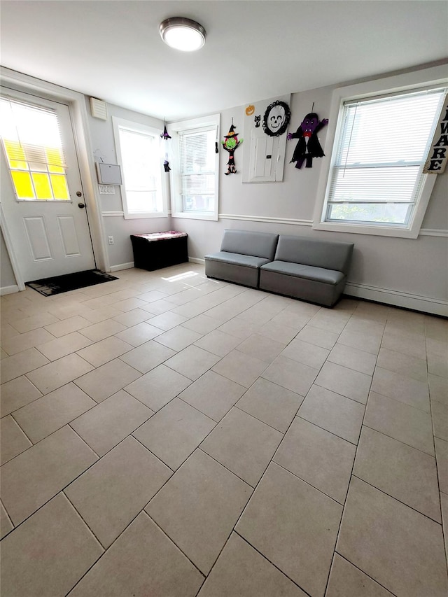 unfurnished living room featuring light tile patterned floors