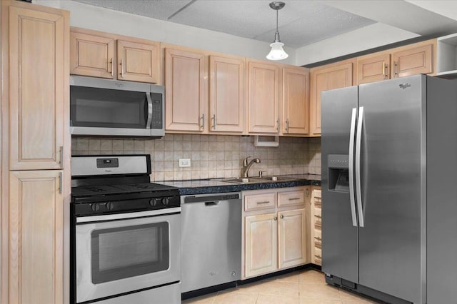 kitchen featuring sink, decorative light fixtures, stainless steel appliances, and light brown cabinets