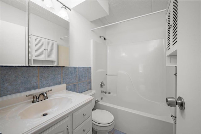 full bathroom featuring toilet, tile walls, vanity, and shower / bathing tub combination