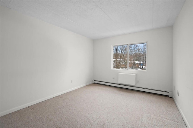 unfurnished room with carpet flooring, a textured ceiling, and a baseboard heating unit