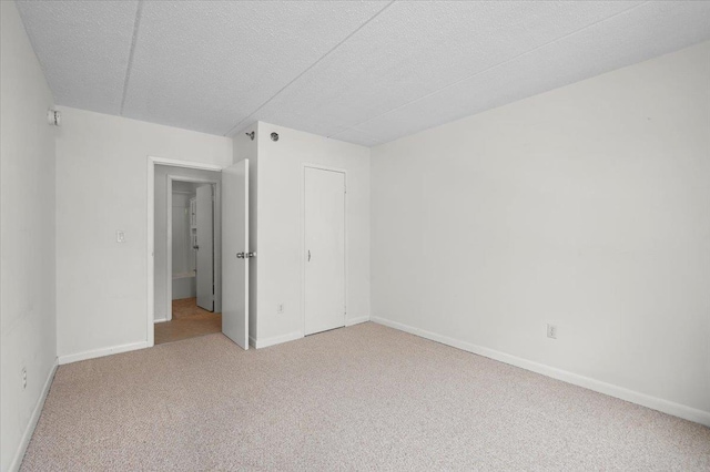 unfurnished room with carpet floors and a textured ceiling