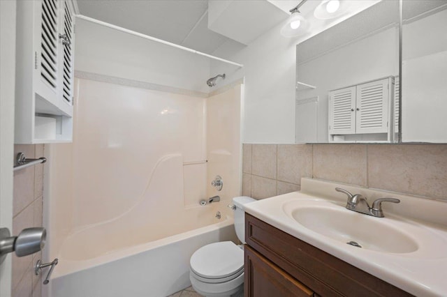 full bathroom with bathing tub / shower combination, tile walls, vanity, and toilet