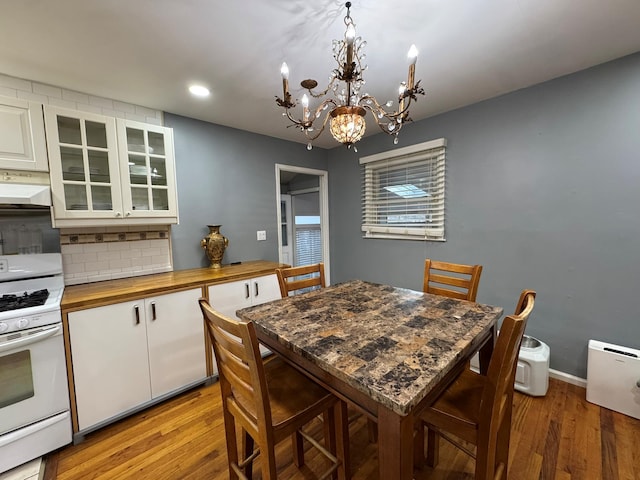 dining room with a notable chandelier and light hardwood / wood-style floors