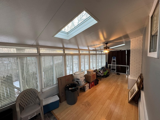 sunroom with ceiling fan and a skylight