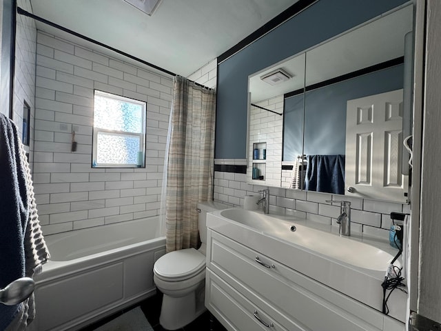 full bathroom featuring shower / bathtub combination with curtain, vanity, tile walls, and toilet